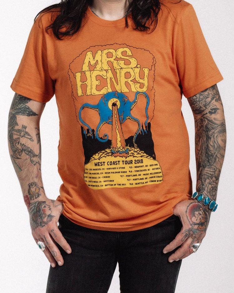 Mrs. Henry West Coast Tour 2018 T-shirt in orange with one-eyed monster artwork by Alex Lexicon, tour dates listed below